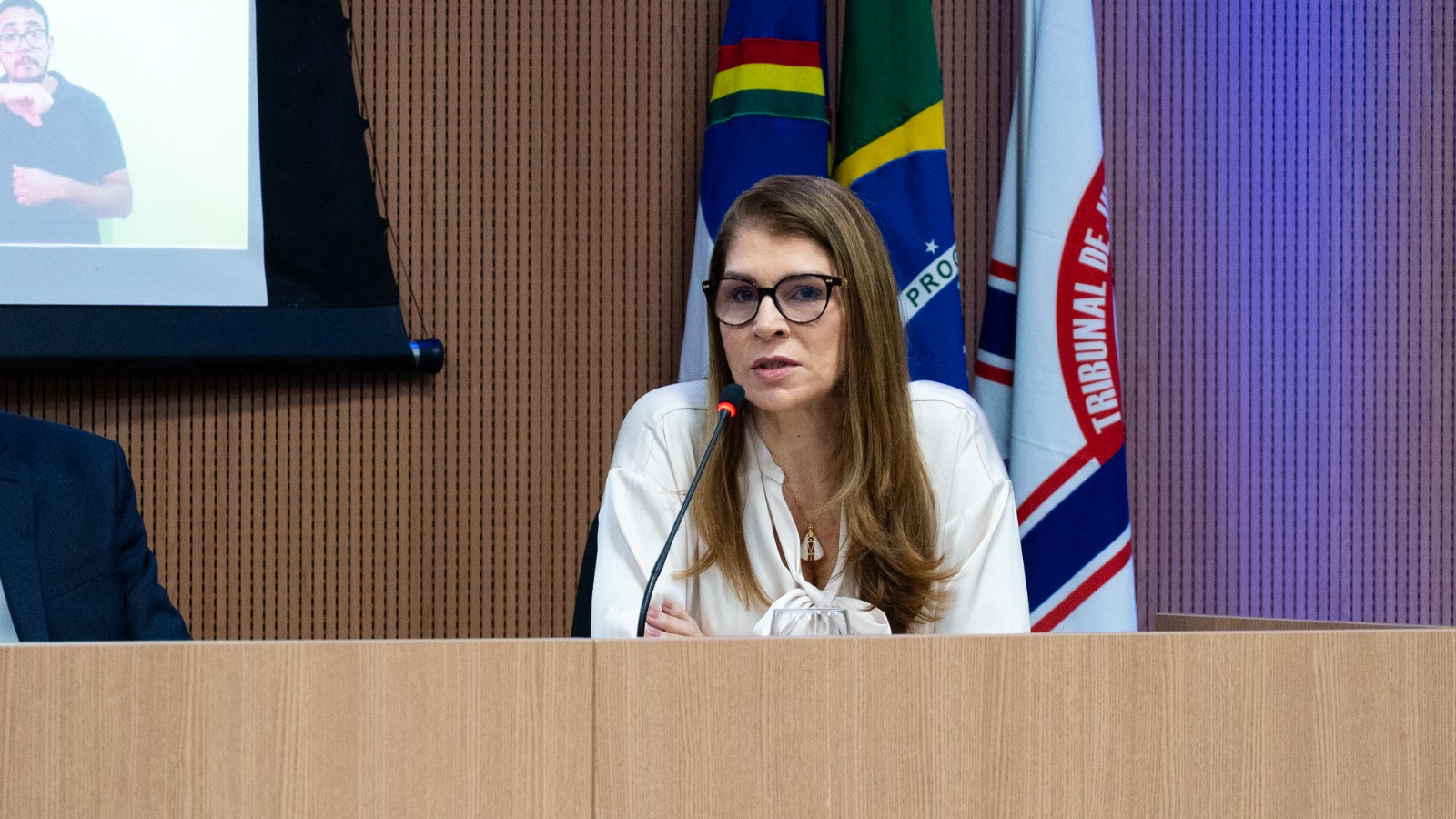 Juíza Roberta Franco falando ao microfone, representando o corregedor-geral